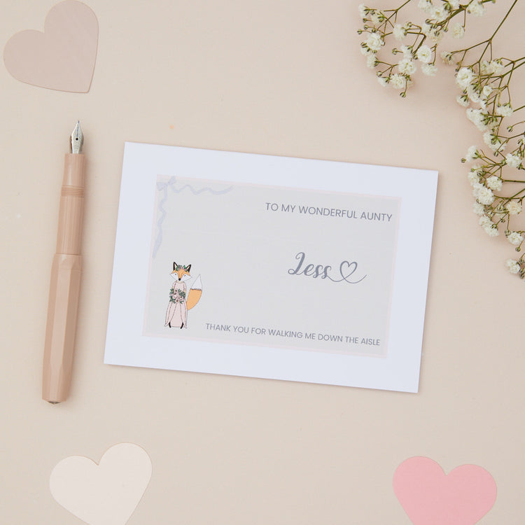 Wedding Aisle Proposal Card & Thanks For Walking Me Down The Aisle Card. Features a Bridal Cartoon character. The Background is a light beige with stationery items and dried flowers surrounding the card.