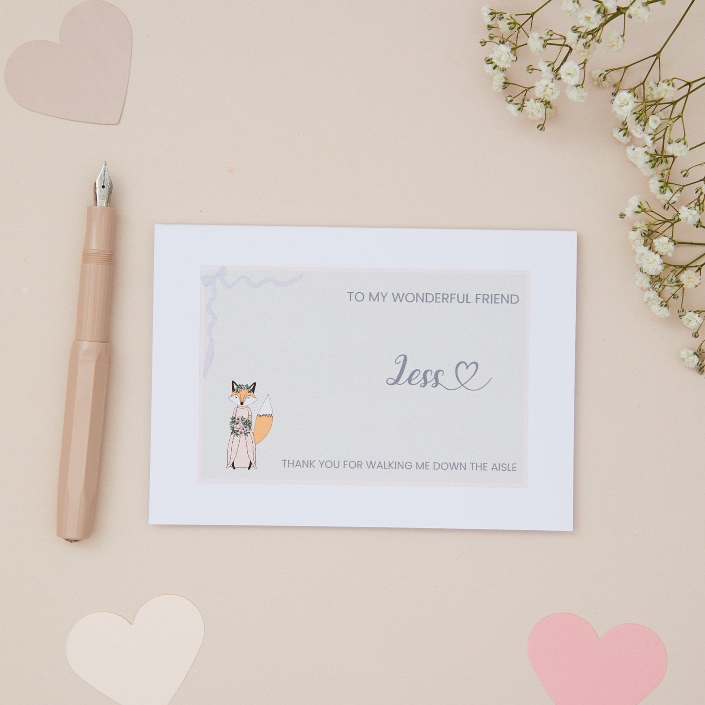 Friend Thanks for walking me down the Aisle Card. A Girl Fox in her bridal attire with the label 'To my wonderful friend thank you for walking me down the aisle. The Card is set against a pale beige background with stationery items.