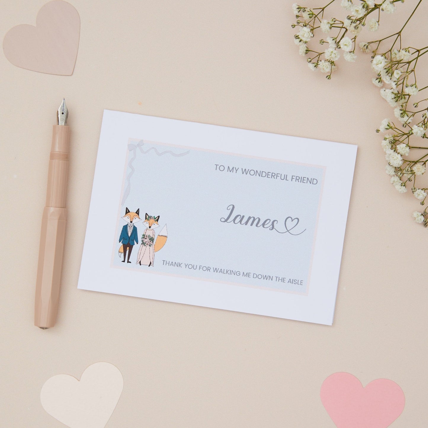 Friend Thanks for walking me down the Aisle Card. A Fox Couple in their bridal attire with the label 'To my wonderful friend thank you for walking me down the aisle. The Card is set against a pale beige background with stationery items.