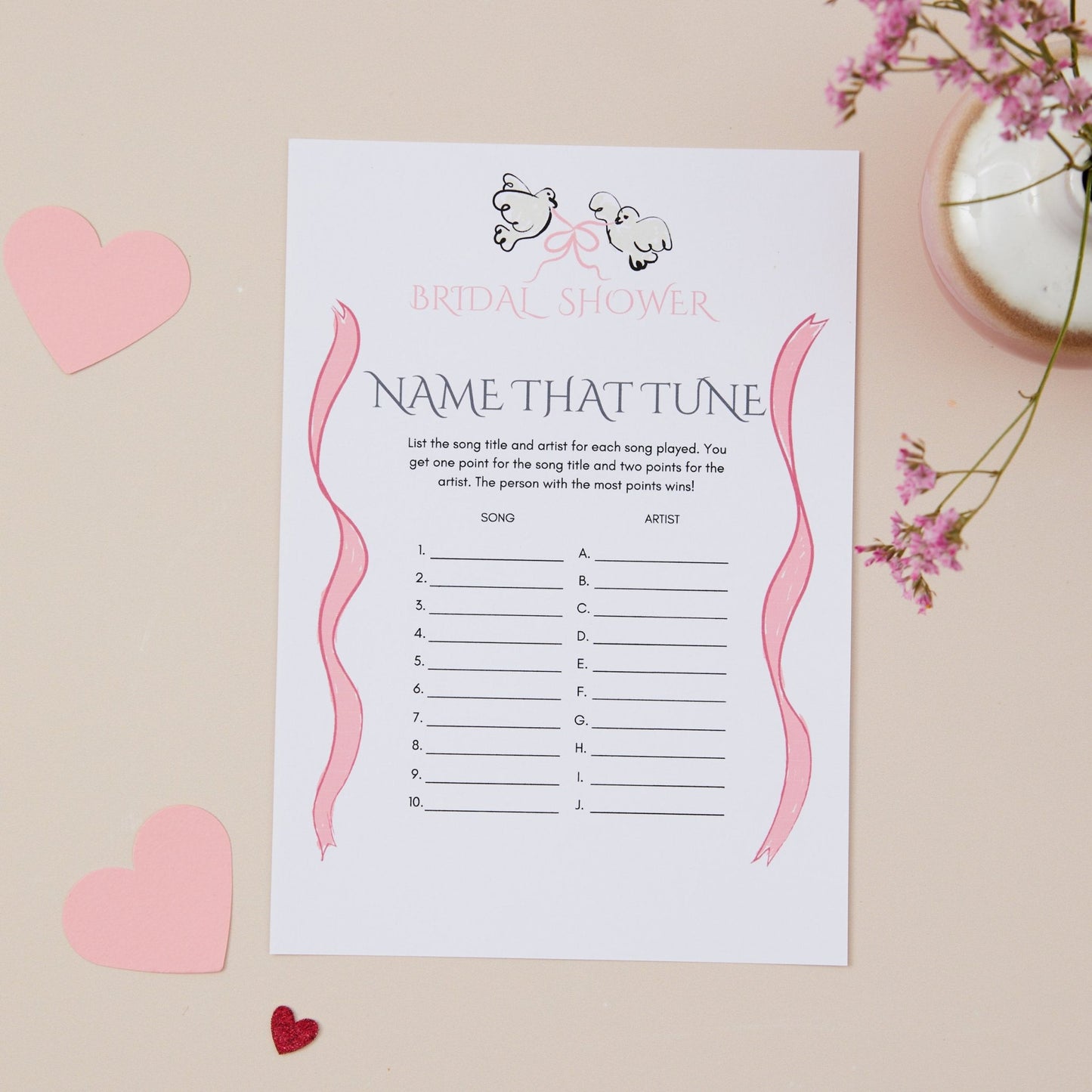 A bridal shower party game titled 'Name That Tune' with blank spaces for guesses, set on a neutral background with decorative elements like pink hearts and flowers.