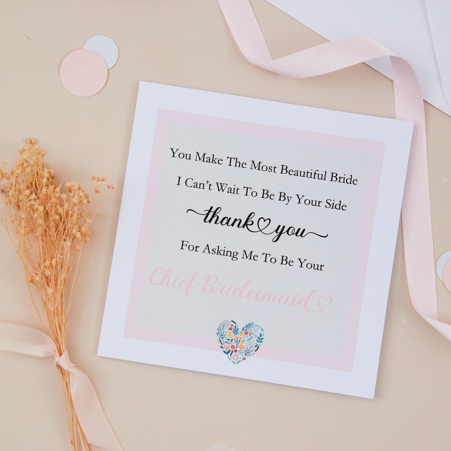 Thanks For Asking Me To Be Your Chief Bridesmaid Card in the form of a poem. At the end of the Poem is a heart which is multicoloured. The Card is against a pale beige background with dried flowers and pink ribbon with confetti shapes.