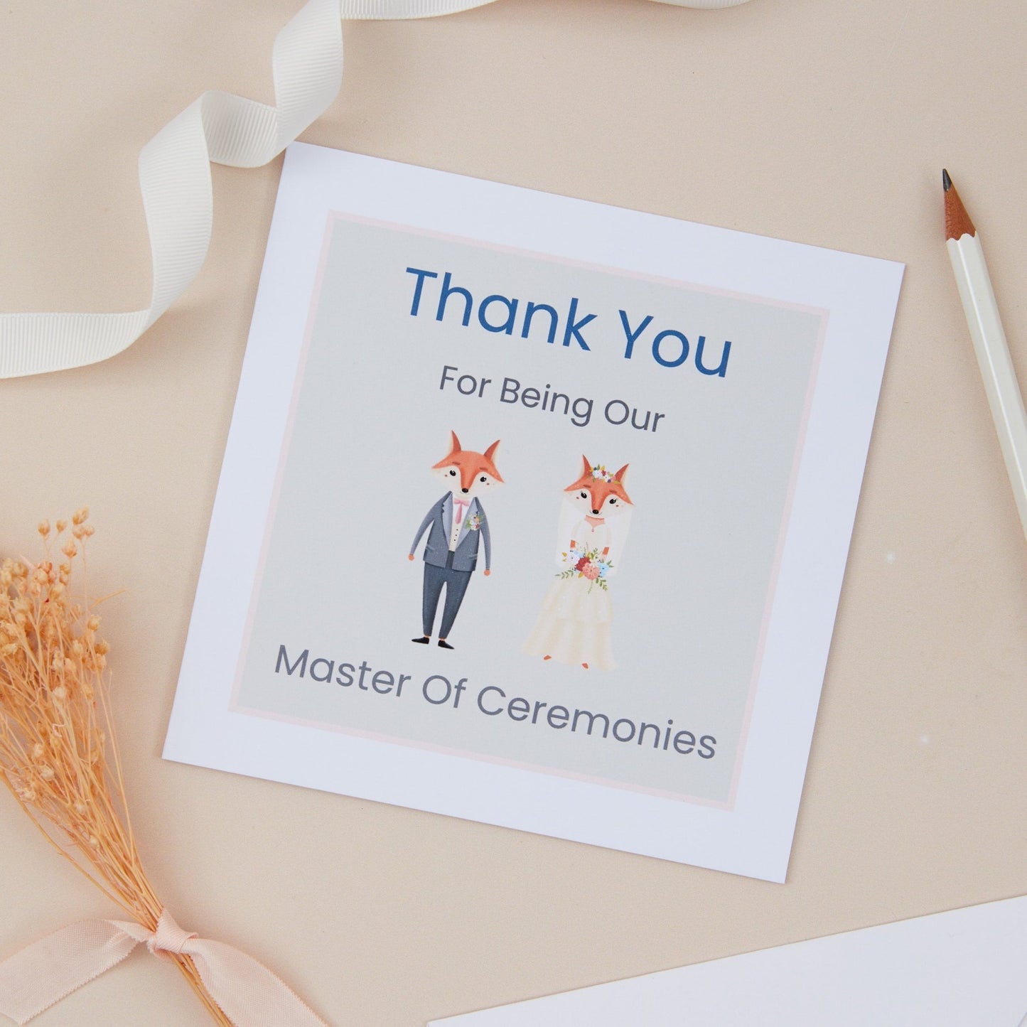 A white, square thank you card with printed text that reads 'Thank You for Being Our Master of Ceremonies', featuring cartoon illustrations of a Fox bride and groom. The card is presented on a beige background with a white ribbon and decorative elements.