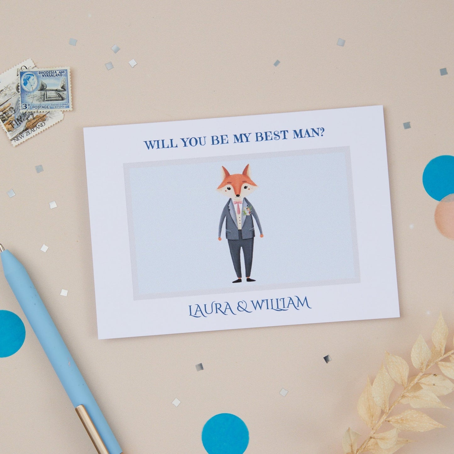 A propositional card with an illustration of a fox in a suit, with the text 'WILL YOU BE MY BEST MAN' above a signature line. The card is presented on a neutral background with some decorative elements like a pen.