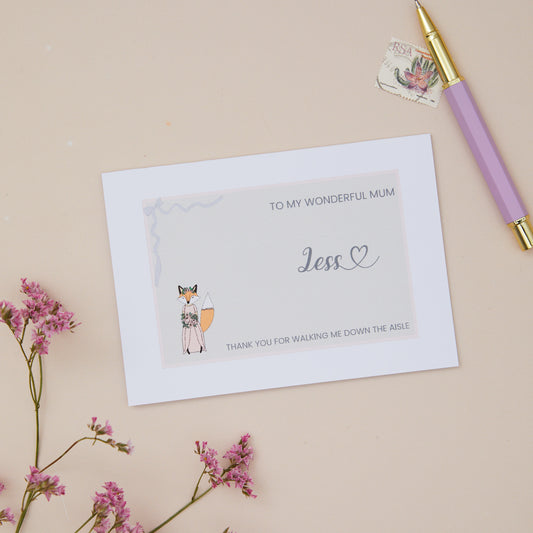 Mum Thanks for walking me down the Aisle Card. A Fox in their bridal attire with the label 'To my wonderful Mum thank you for walking me down the aisle. The Card is set against a pale beige background with stationery items.