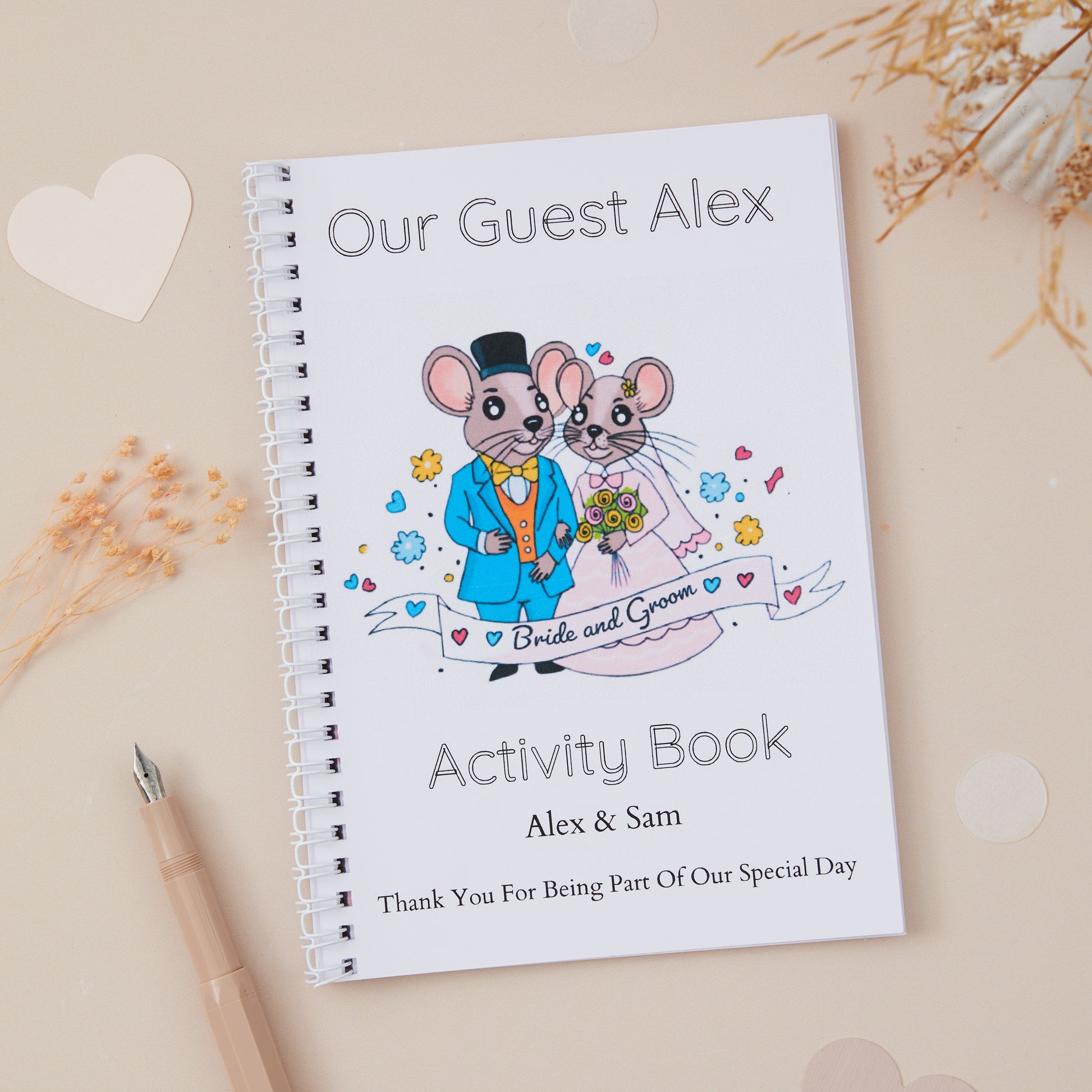 A5-sized wedding activity book with a 'Mr & Mrs Mouse' design, featuring illustrations of a mouse couple in formal attire, suitable for personalisation with the name of the child guest, couple getting  married and their wedding date.
